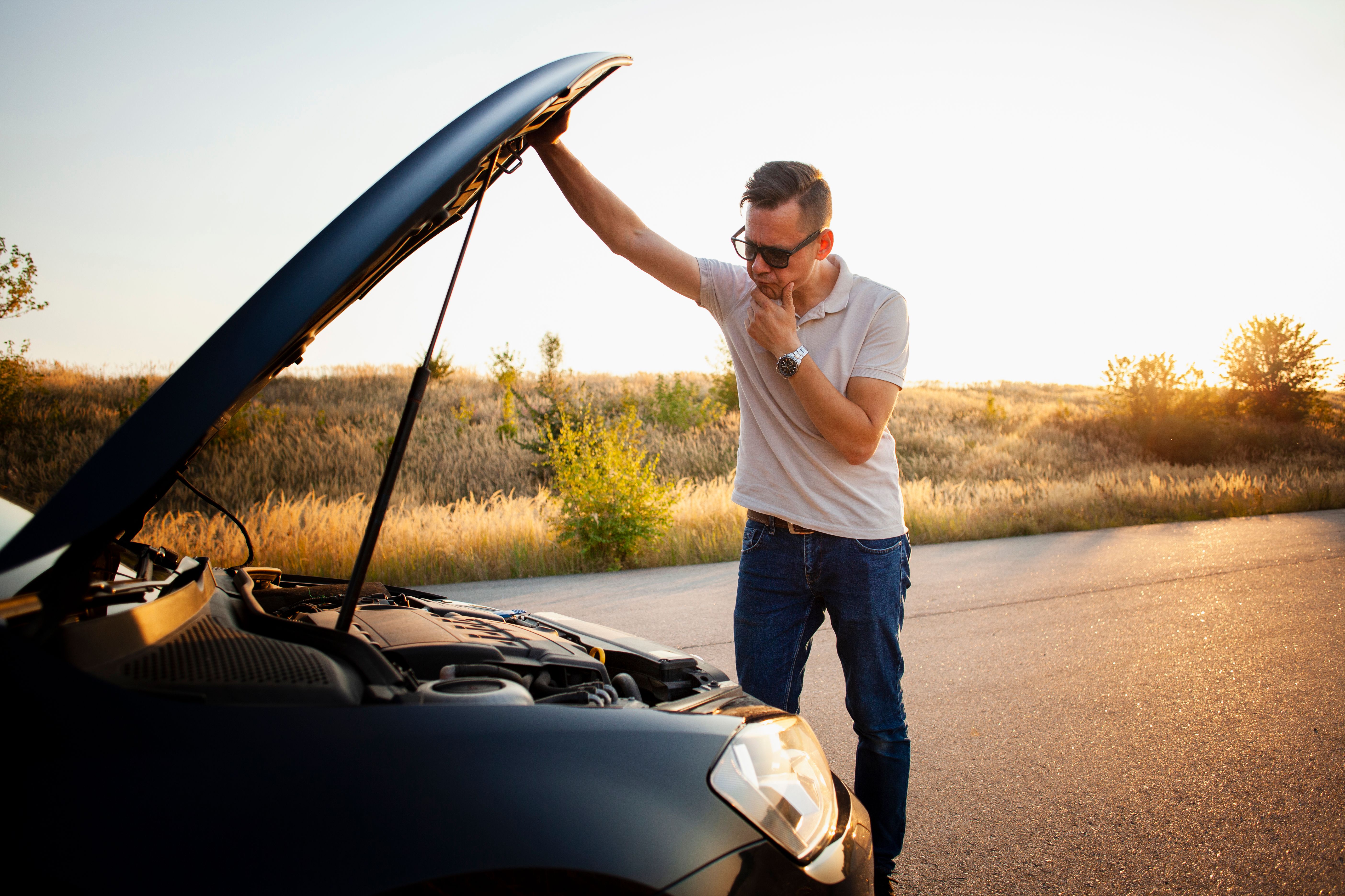 young-man-checking-car-engine - FREEPIK