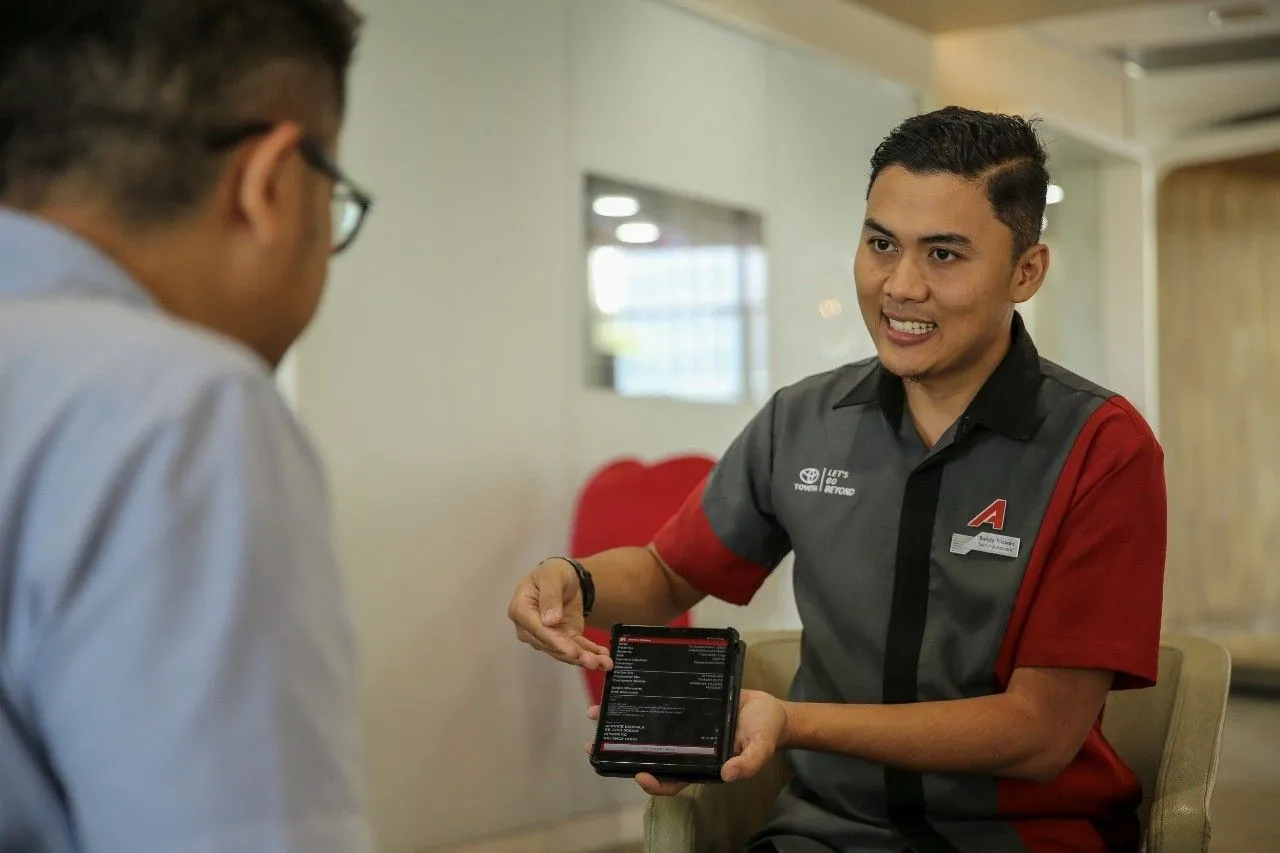 Service Advisor Auto2000 sedang memberikan penjelasan komponen apa saja yang wajib dicek dan diperhatikan pada mobil hybrid Toyota. (Auto2000)
